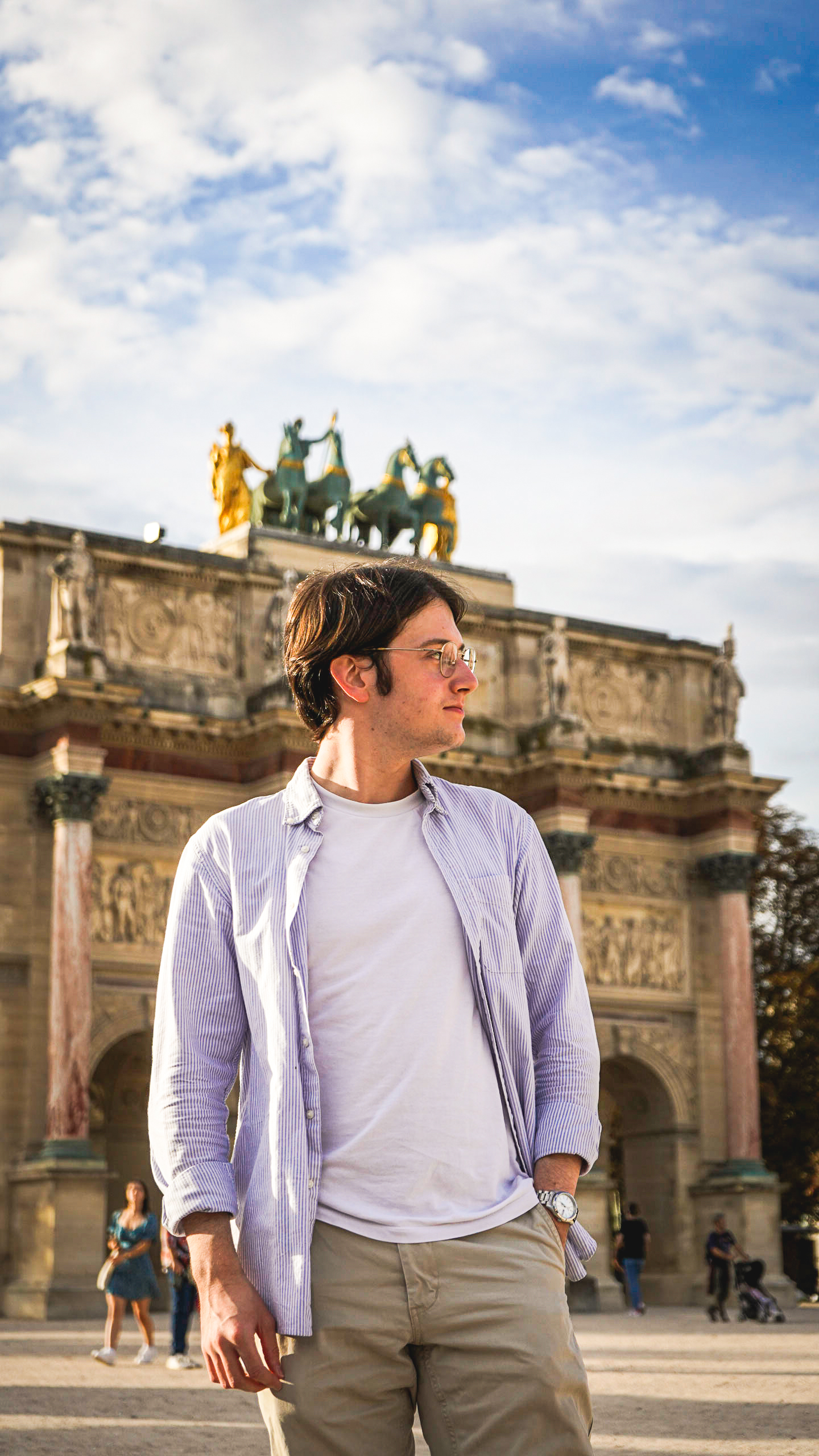 A tourist visiting Paris next to the Louvre museum