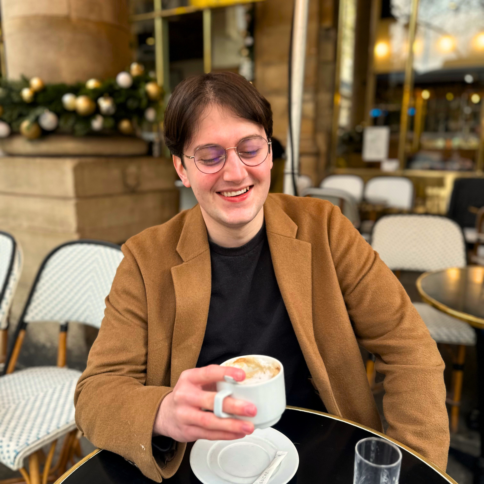 A French guy in Paris drinking coffee in a French café